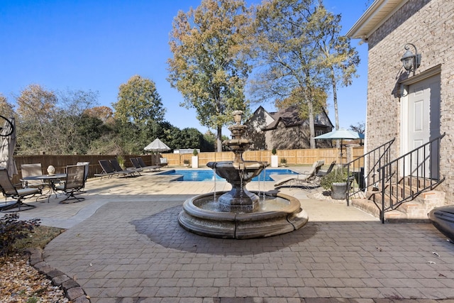 view of patio / terrace with a fenced in pool