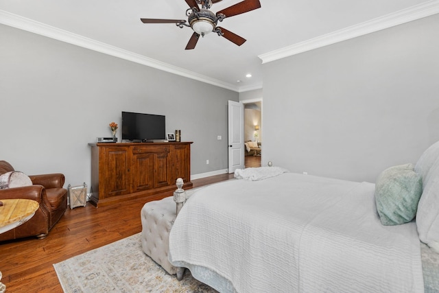 bedroom featuring ceiling fan, crown molding, and wood-type flooring