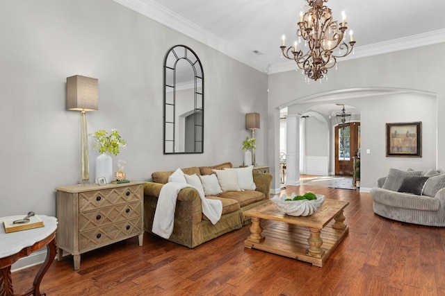 living room featuring a chandelier, hardwood / wood-style floors, and crown molding