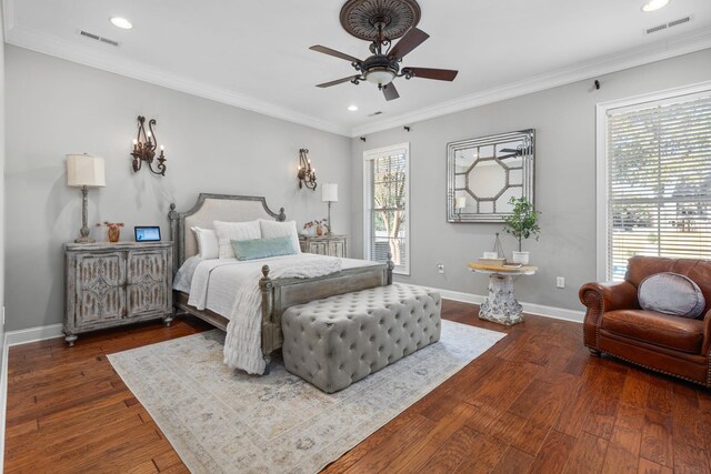 bedroom featuring ceiling fan, dark hardwood / wood-style floors, and ornamental molding