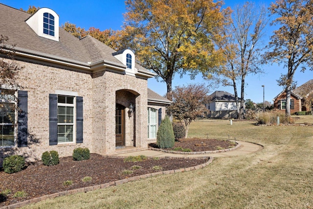 view of home's exterior with a yard