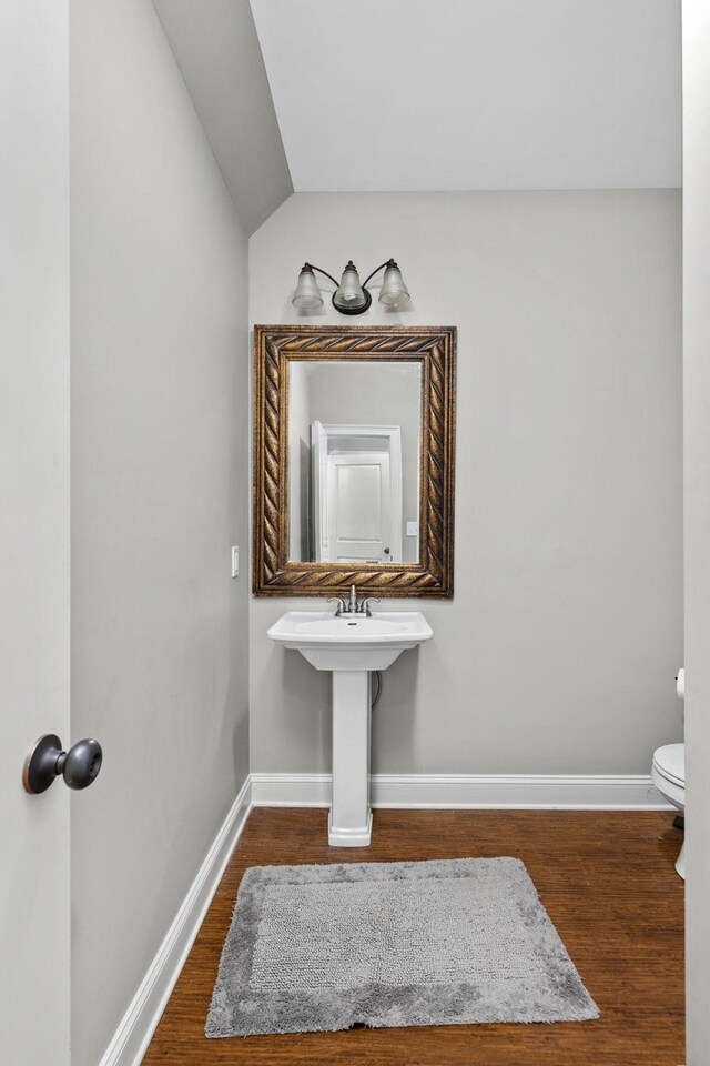 bathroom with sink, wood-type flooring, and toilet