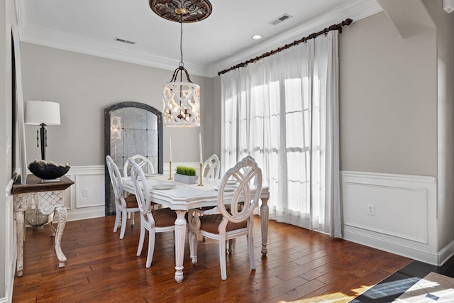 dining space featuring a wealth of natural light, crown molding, and dark hardwood / wood-style floors