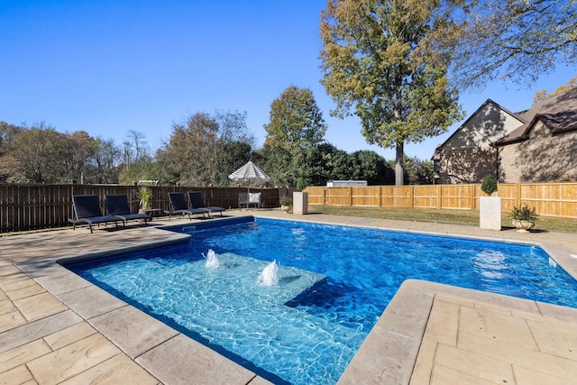 view of swimming pool with a patio and pool water feature