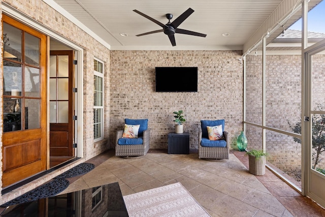 unfurnished sunroom with ceiling fan