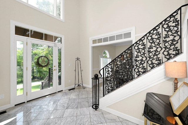 foyer entrance featuring a high ceiling and a wealth of natural light