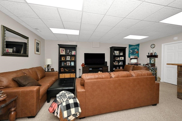 living room with carpet flooring and a paneled ceiling