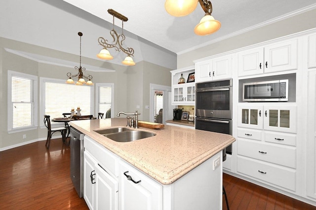 kitchen featuring a center island with sink, white cabinetry, and sink