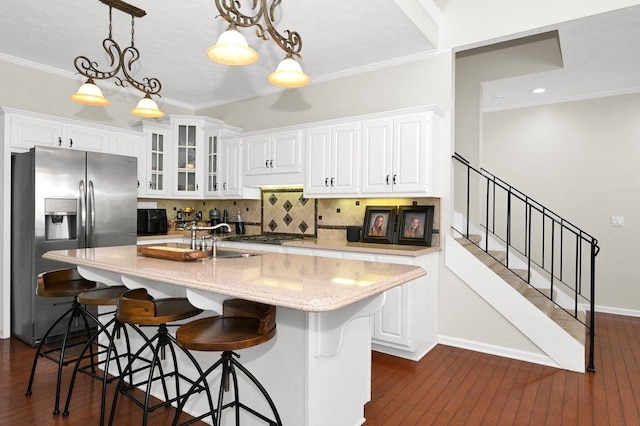 kitchen with crown molding, sink, white cabinetry, and stainless steel refrigerator with ice dispenser