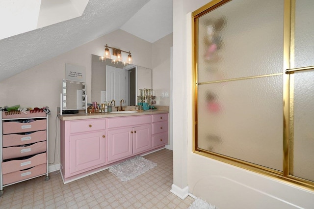 bathroom with vanity, a textured ceiling, lofted ceiling, and enclosed tub / shower combo