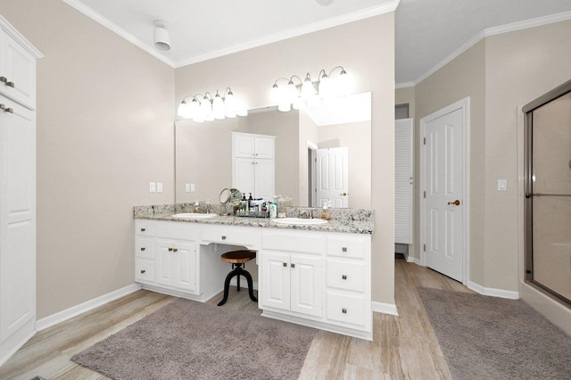 bathroom featuring vanity, hardwood / wood-style flooring, a shower with door, and crown molding