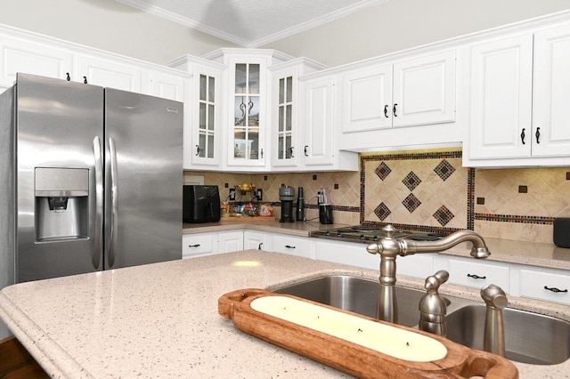 kitchen featuring backsplash, crown molding, sink, stainless steel fridge with ice dispenser, and white cabinetry