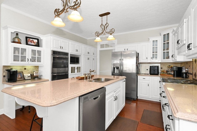 kitchen featuring decorative backsplash, white cabinets, and appliances with stainless steel finishes