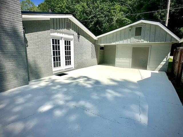  - exterior space featuring brick siding and board and batten siding