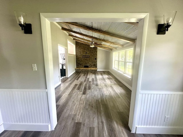  - unfurnished living room featuring a ceiling fan, dark wood-type flooring, wainscoting, and a fireplace