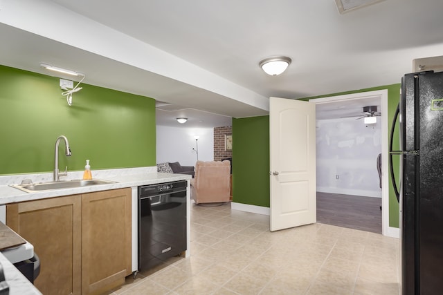 kitchen with black appliances, ceiling fan, and sink