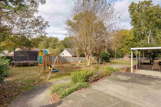 view of yard with a patio, a playground, and a trampoline