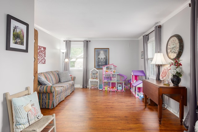 game room featuring hardwood / wood-style flooring, a healthy amount of sunlight, and crown molding