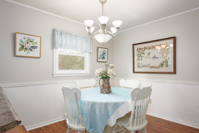 dining space with a chandelier, dark hardwood / wood-style flooring, and crown molding