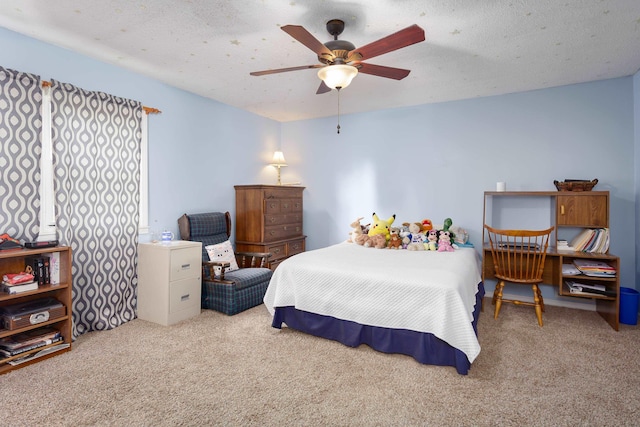 carpeted bedroom with ceiling fan and a textured ceiling