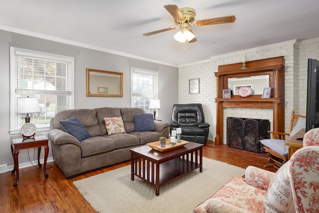 living room featuring a brick fireplace, ceiling fan, brick wall, and hardwood / wood-style flooring