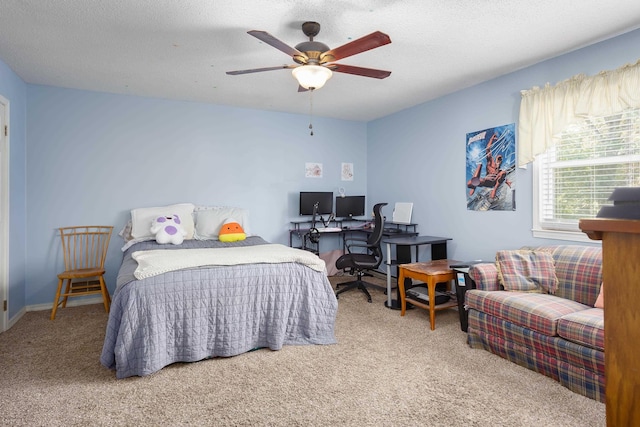 carpeted bedroom with ceiling fan and a textured ceiling