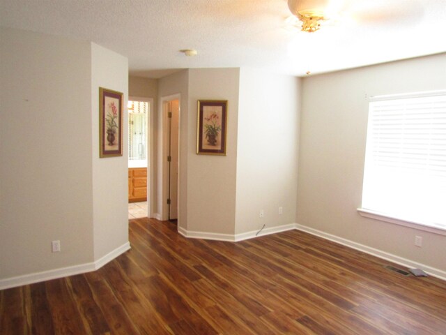 empty room with dark hardwood / wood-style flooring