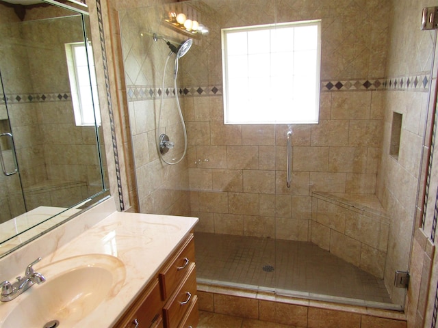 bathroom featuring vanity and an enclosed shower