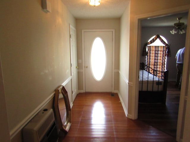 doorway to outside featuring dark wood-type flooring