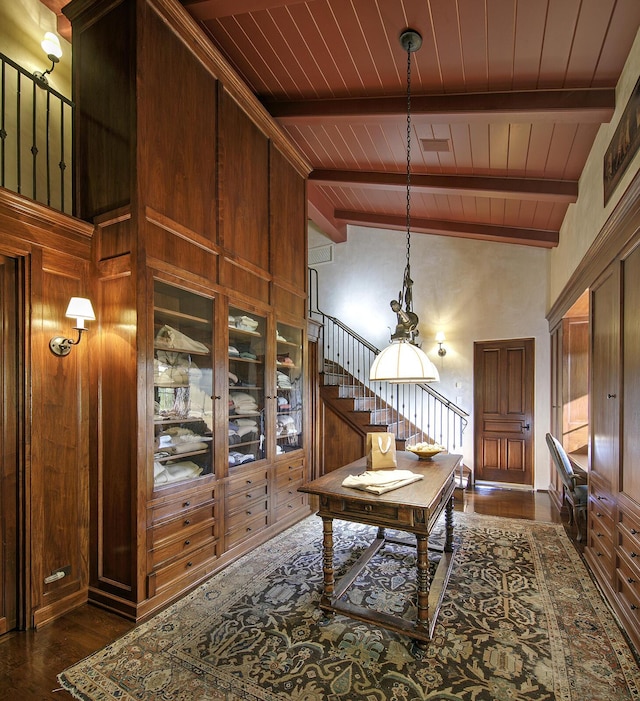 dining space featuring beam ceiling, dark wood-type flooring, high vaulted ceiling, wood walls, and wood ceiling