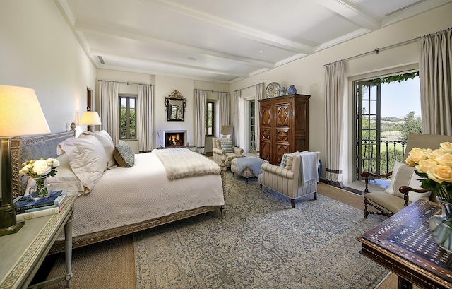 carpeted bedroom with beam ceiling and access to outside