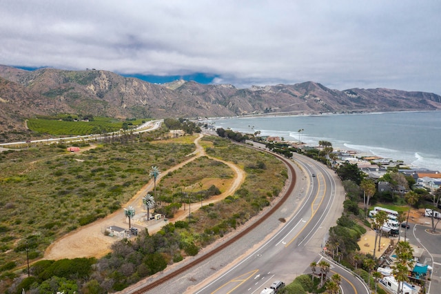 birds eye view of property with a water and mountain view