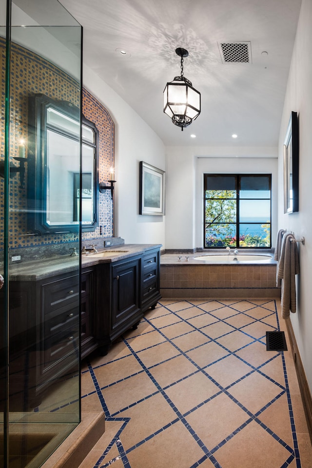 bathroom featuring tasteful backsplash, tile floors, and vanity