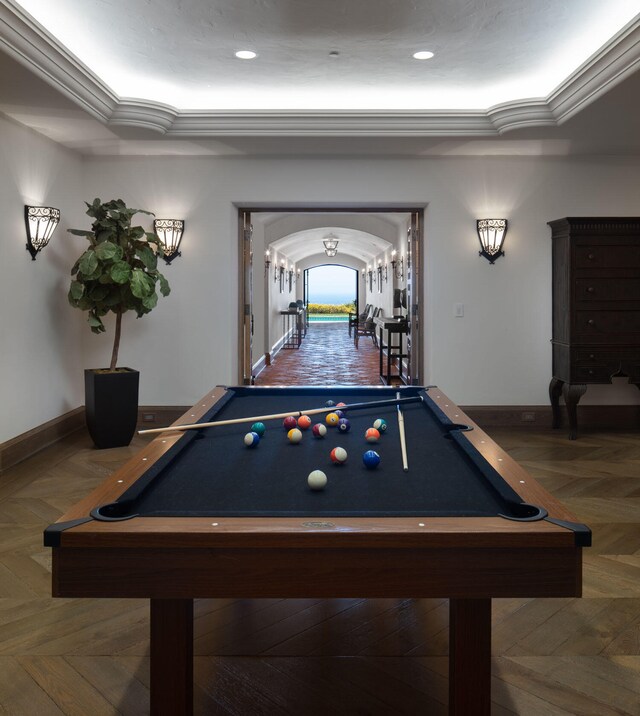 playroom with dark parquet flooring, ornamental molding, and pool table