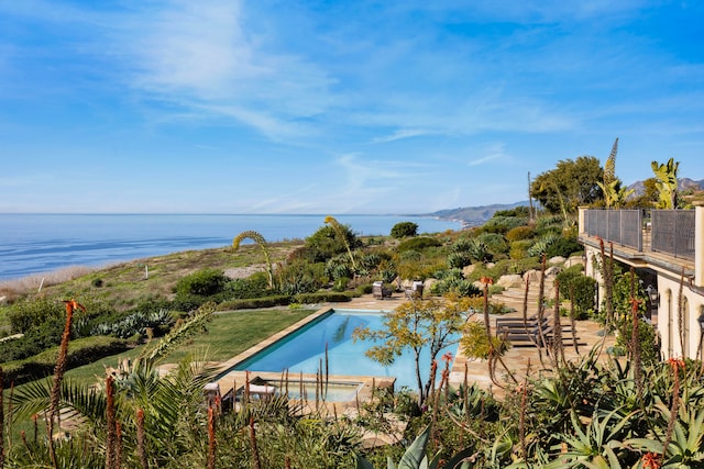 view of swimming pool featuring a water view