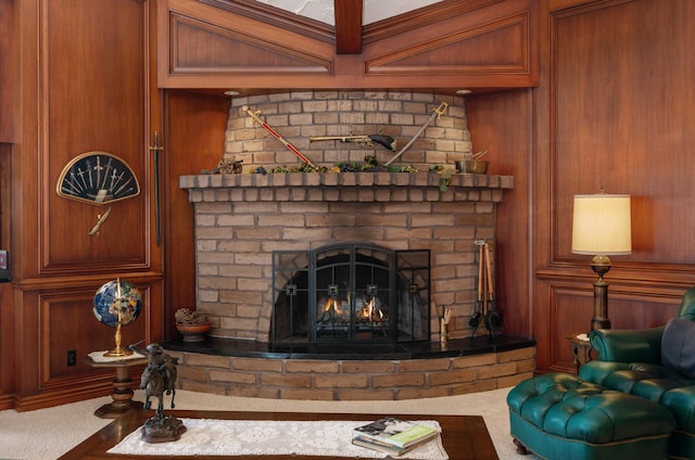 carpeted living room with wood walls and a brick fireplace