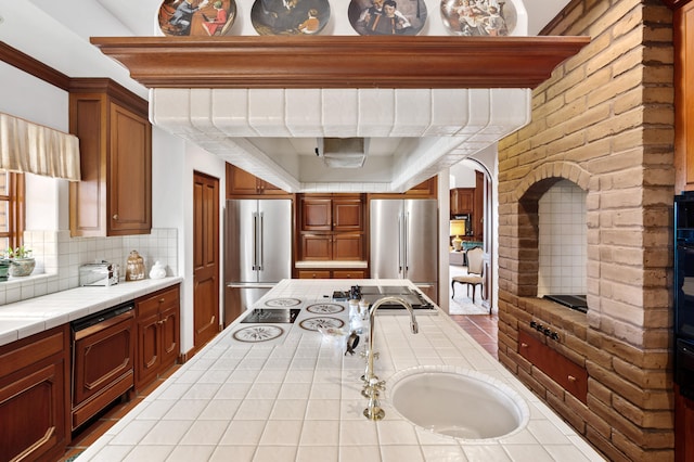 kitchen featuring sink, tile countertops, stainless steel refrigerator, and high end fridge