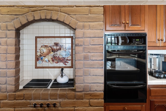 kitchen featuring backsplash and double oven