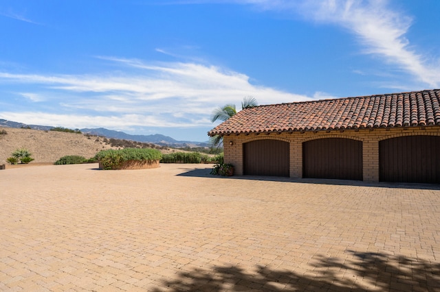 exterior space featuring a mountain view and a garage