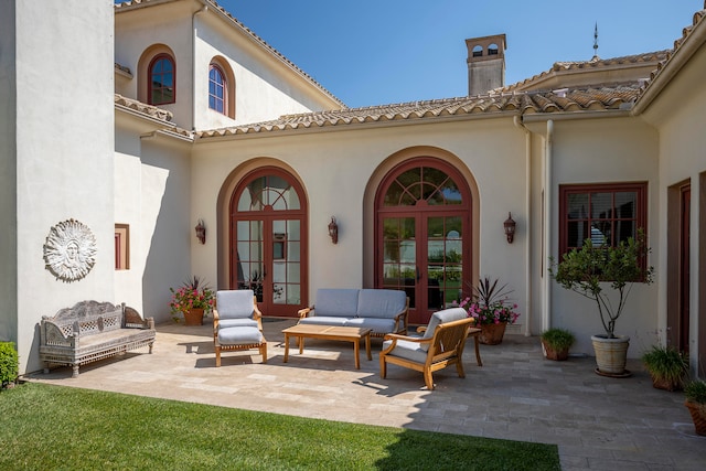 back of house with french doors, outdoor lounge area, and a patio