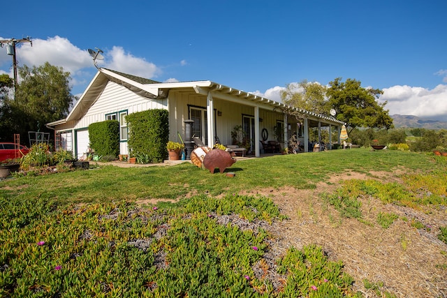 rear view of house featuring a lawn and a pergola