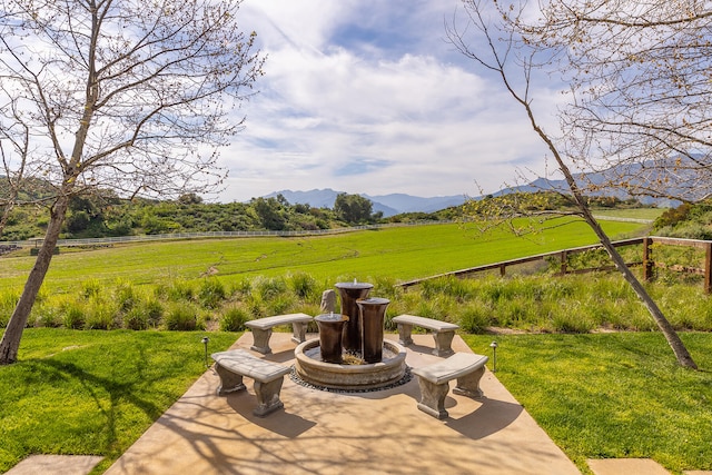 view of patio / terrace with a mountain view and a rural view