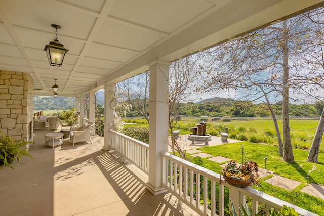 view of patio featuring a mountain view and an outdoor living space