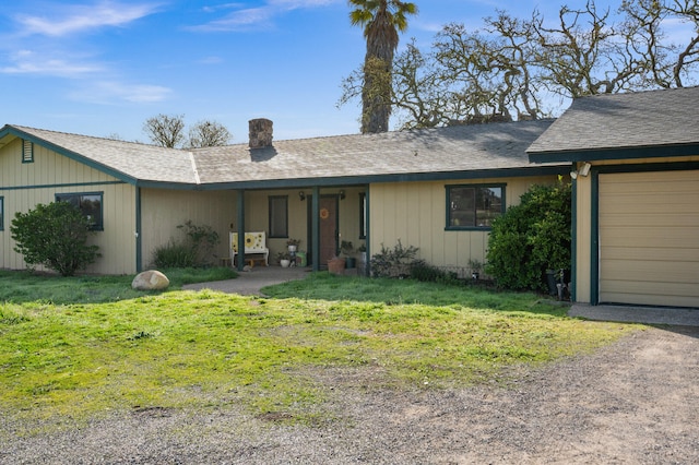 ranch-style house featuring a front yard, driveway, and an attached garage