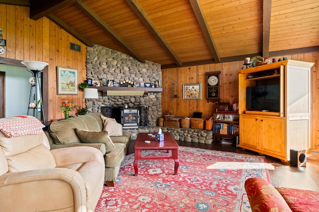 living area featuring lofted ceiling with beams, wood ceiling, wood finished floors, and wooden walls
