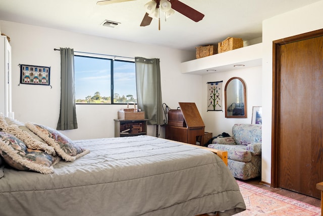 bedroom featuring visible vents, wood finished floors, and a ceiling fan