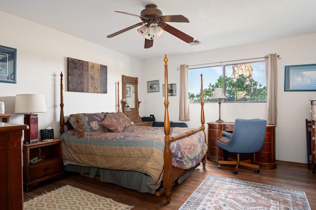 bedroom with visible vents, wood finished floors, and a ceiling fan