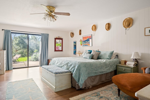 bedroom featuring ceiling fan, access to outside, and wood finished floors
