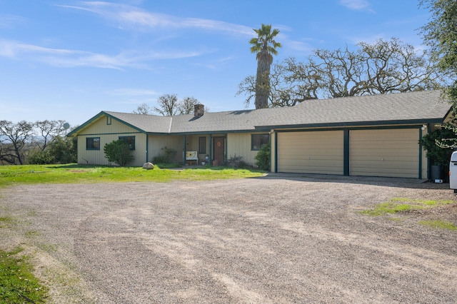 single story home with driveway, an attached garage, and a chimney