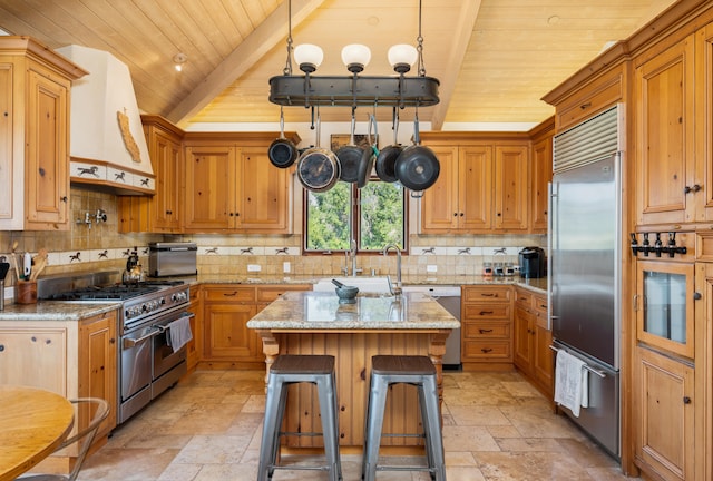 kitchen featuring a breakfast bar, wood ceiling, high end appliances, and light tile flooring